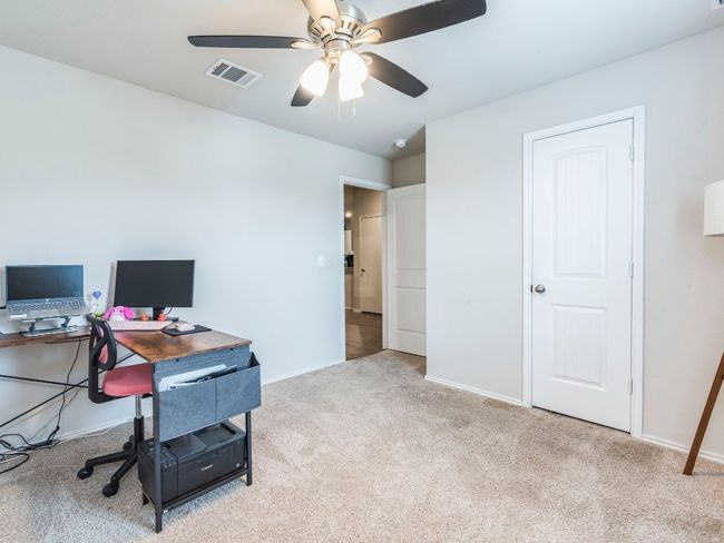 Home office with a ceiling fan, carpet floors, baseboards, and visible vents | Image 22