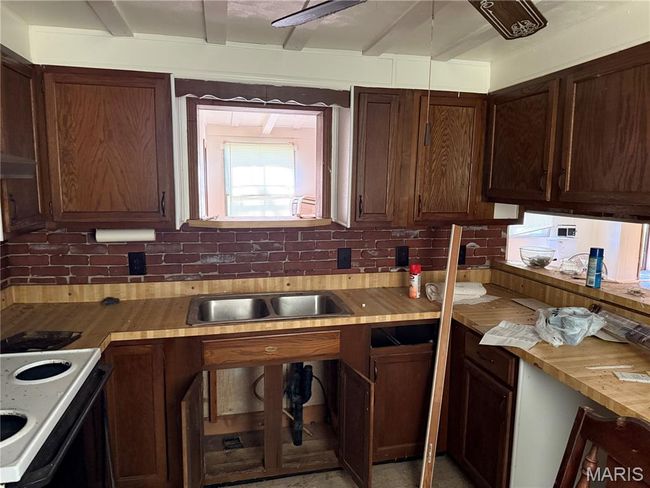 Kitchen with electric range, wooden counters, and decorative backsplash | Image 14