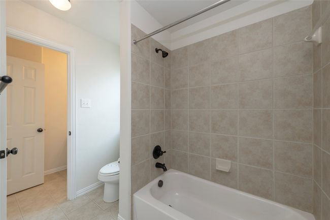 Full bathroom featuring tile patterned flooring and shower / bath combination | Image 31