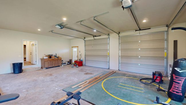 Garage with recessed lighting and a garage door opener | Image 19