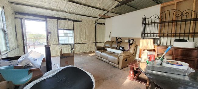 Above the huge carport is a 2 bedroom, 1 bath guest apartment. This is the living room. Solid steel structure with electricity and plumbing, ready for sheetrock, paint and your choice of flooring. | Image 17