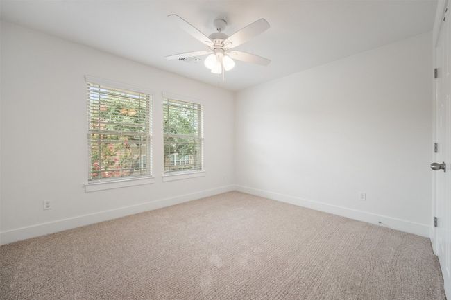 The upstairs guest bedroom offers plenty of natural light, making it a bright and welcoming space for family or visitors to feel right at home | Image 27