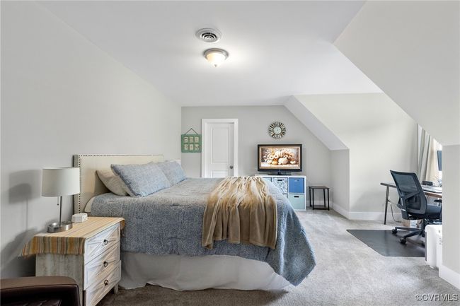 Carpeted bedroom featuring baseboards and visible vents | Image 24