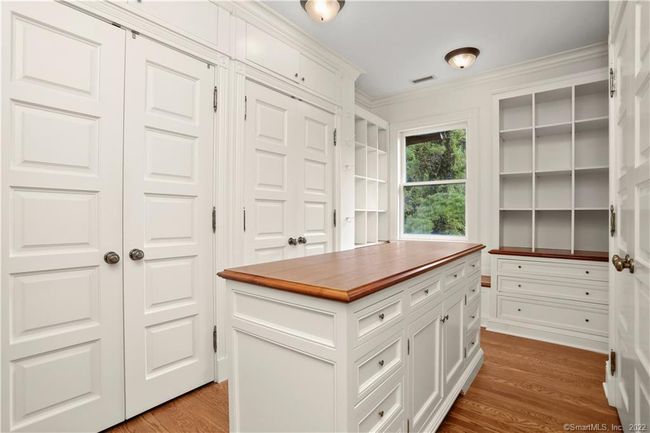 PRIMARY SUITE // One of two dressing rooms complete with closets, spacious shoe storage, multiple built ins and center island. | Image 20