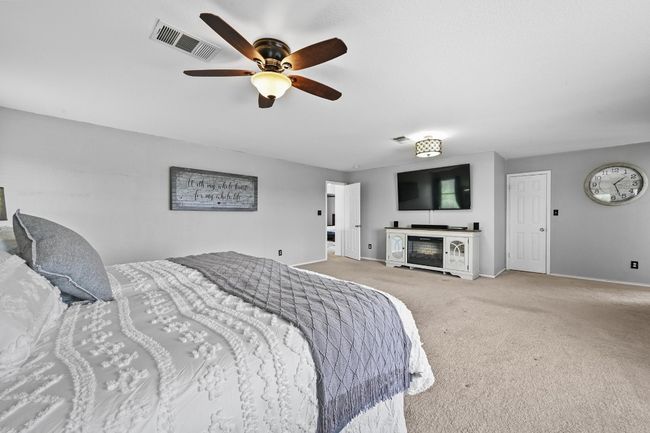 Bedroom with carpet, baseboards, and a ceiling fan | Image 24