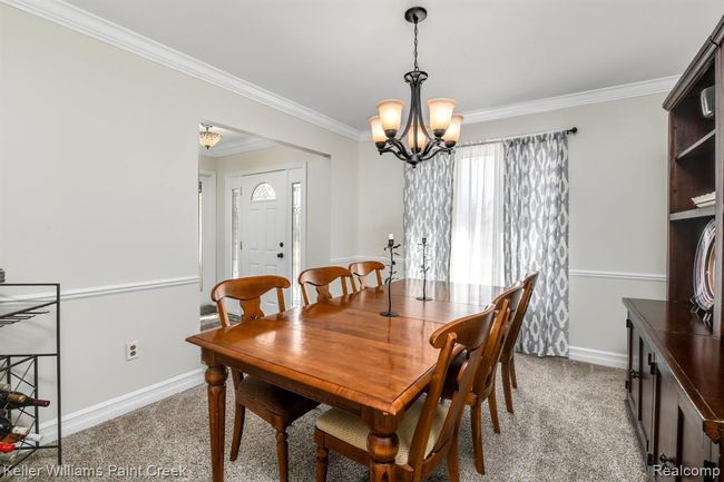 Formal dining room flanks the entryway and offers freshened decor. | Image 5