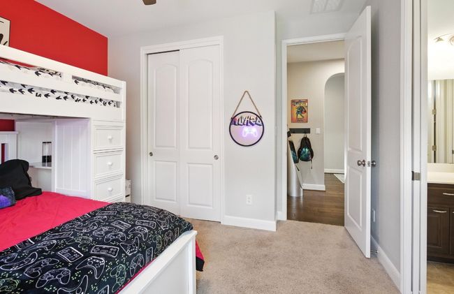 Carpeted bedroom featuring arched walkways and a closet | Image 25