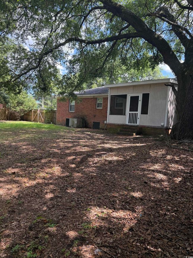 Single story home featuring crawl space, driveway, brick siding, a front yard, and an attached carport | Image 16