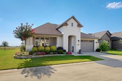 One story Highland model with white brick front and tandem golf cart garage | Image 1