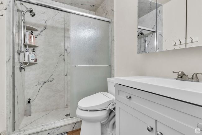Bathroom with vanity and a marble finish shower | Image 15
