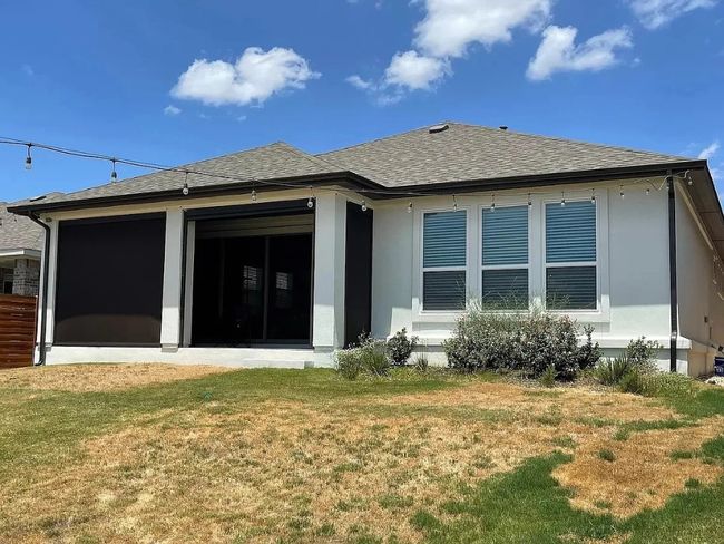 Rear view of house featuring roof with shingles, a yard, and a sunroom | Image 15