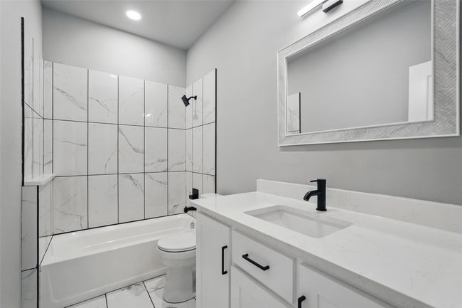 Bathroom with vanity, bathtub / shower combination, marble finish floor, toilet, and recessed lighting | Image 21