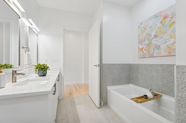 Fall in love with the spa-like primary bath—sleek surfaces, clean lines, and calming natural light throughout. | Image 21