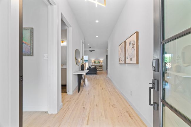 Hallway with light wood-type flooring and recessed lighting | Image 7