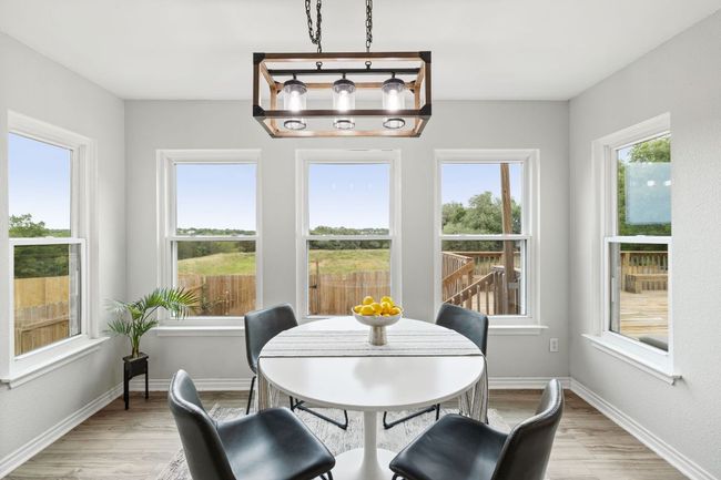 Dining space with light wood-style flooring and baseboards | Image 18
