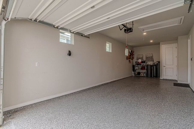 Garage with a garage door opener and baseboards | Image 23
