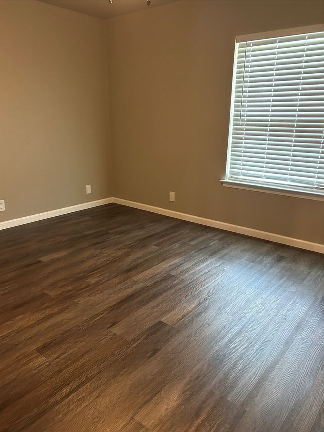 Spare room featuring baseboards and dark wood finished floors | Image 29