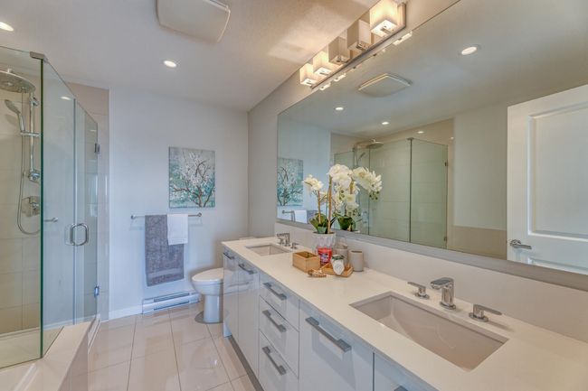 Full bath with a shower stall, tile patterned flooring, double vanity, and recessed lighting | Image 20