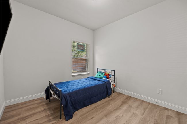 Bedroom featuring wood finished floors and baseboards | Image 25