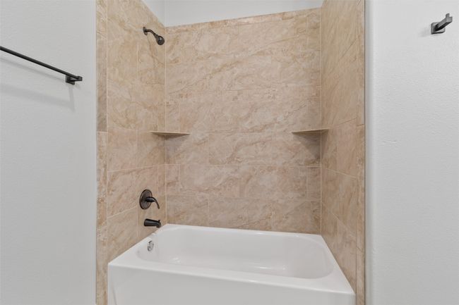 Bathroom featuring tiled shower / bath combo | Image 22