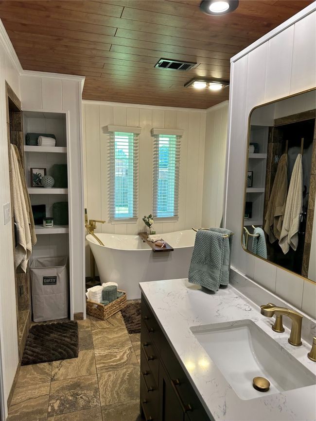 Full bathroom featuring wood ceiling, vanity, a freestanding bath, and crown molding | Image 20