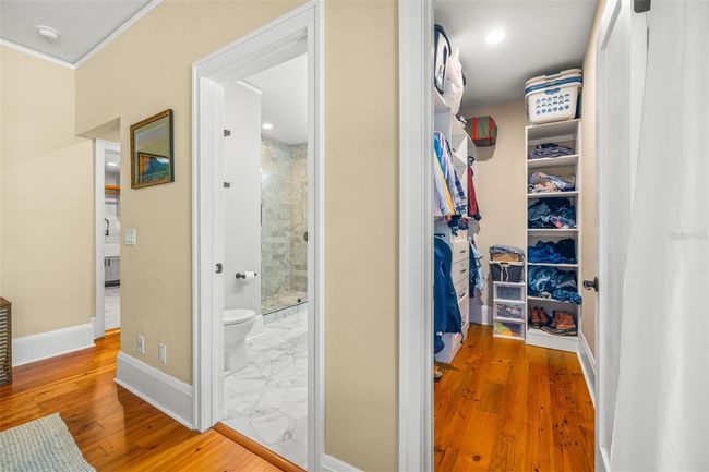 Walk-in closet with organizers. | Image 21