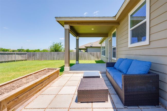 Fenced backyard with a patio area and an outdoor living space | Image 26