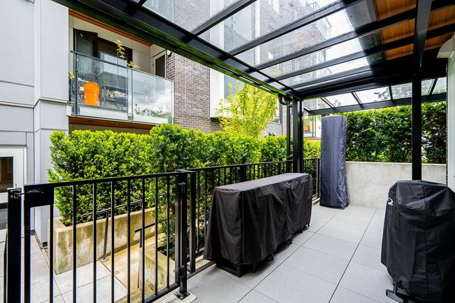 View of patio featuring a pergola and grilling area | Image 16