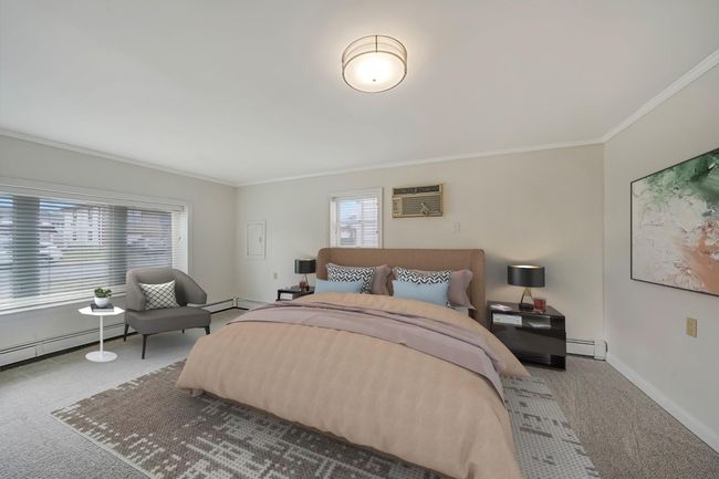 Bedroom featuring carpet flooring, ornamental molding, and a baseboard radiator | Image 28