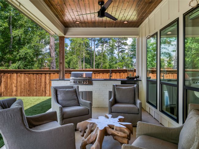 View of patio / terrace with an outdoor kitchen, a ceiling fan, and view of scattered trees | Image 30