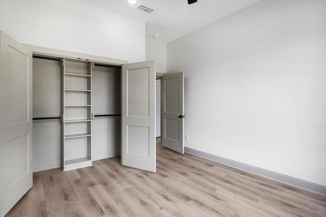 Unfurnished bedroom featuring light wood-style flooring, a closet, and ceiling fan | Image 35