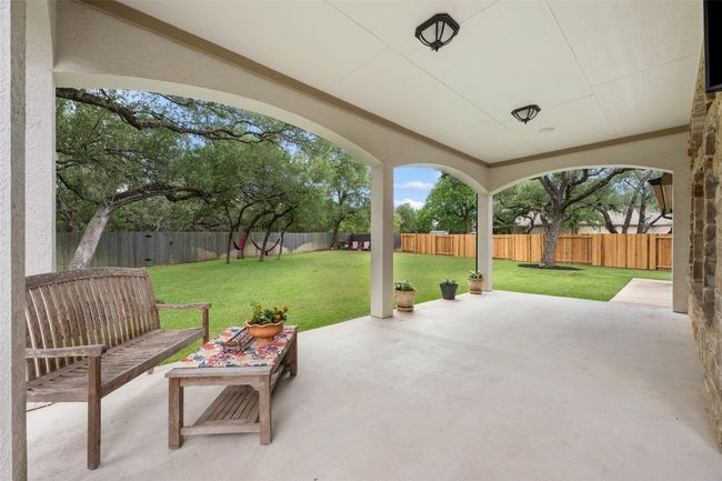 Fenced backyard with a patio | Image 32