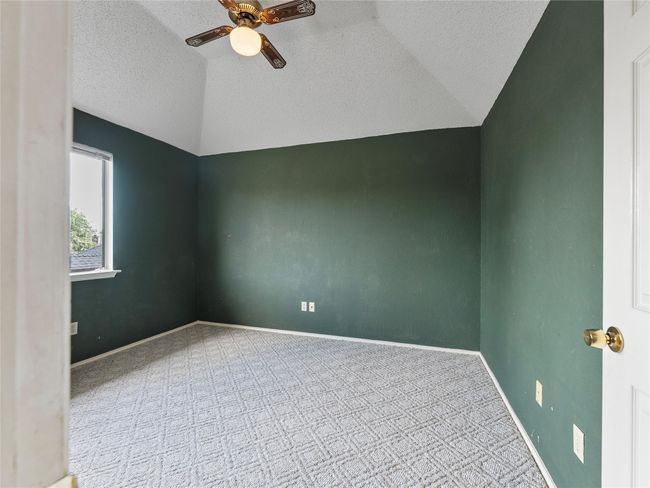 Additional living space with lofted ceiling, ceiling fan, carpet, and a textured ceiling | Image 24