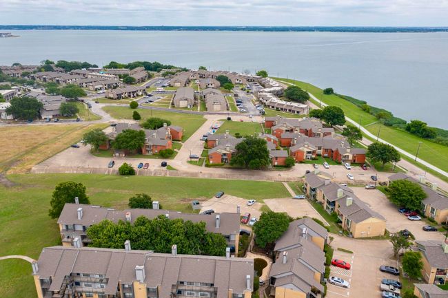 Aerial perspective of suburban area featuring a nearby body of water | Image 7