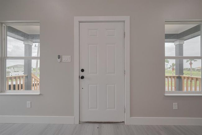 Looking inward from the front door, the layout opens directly into the heart of the home—welcoming you into the bright and airy shared living space. | Image 6