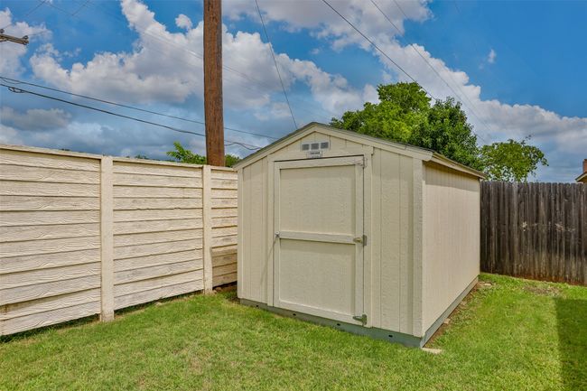 View of shed with a fenced backyard | Image 39