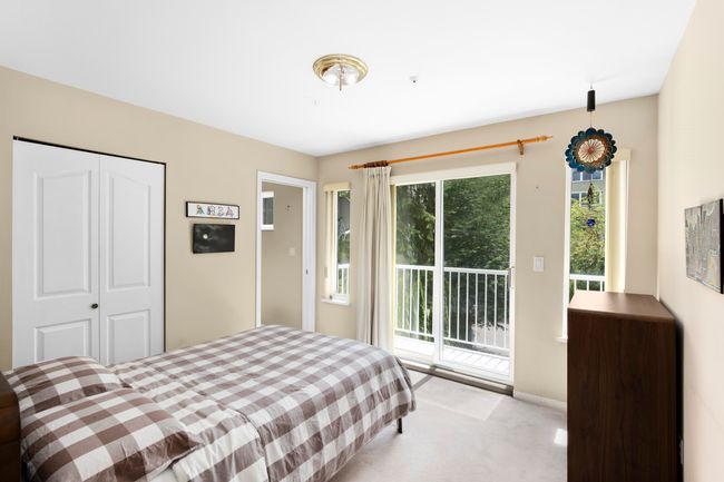 Bedroom with access to outside, light carpet, multiple windows, and a closet | Image 21