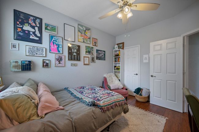 Bedroom with wood finished floors and ceiling fan | Image 20