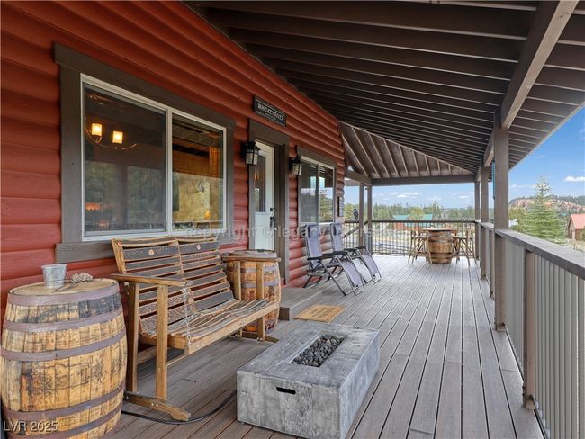 Wooden deck featuring an outdoor fire pit | Image 30