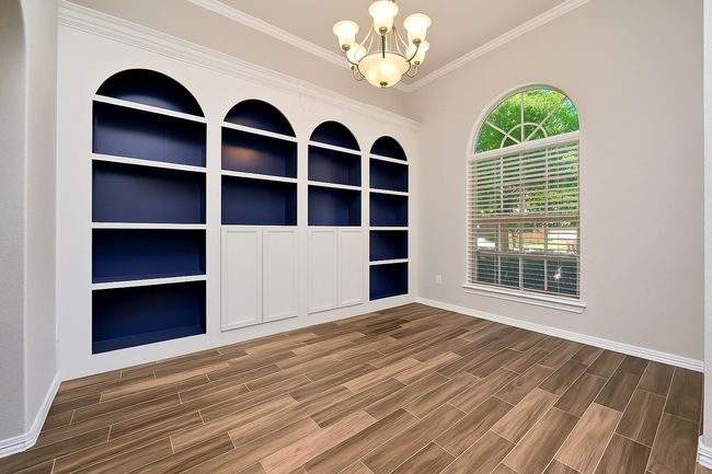 Exquisitely custom-built cabinets located in this flex room - perfect for hosting family meals or to be used as Office | Image 13
