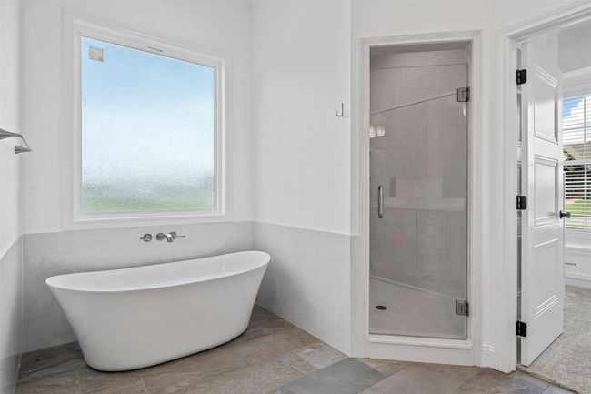 Bathroom featuring a stall shower and a freestanding bath | Image 18
