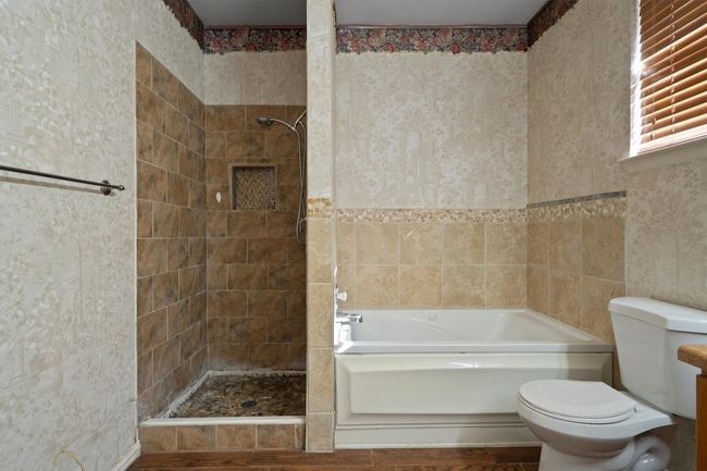 Bathroom featuring tiled shower, and a bathtub | Image 24