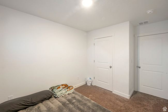 Unfurnished bedroom with carpet floors and baseboards | Image 13