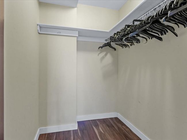 Spacious closet featuring dark wood finished floors | Image 10