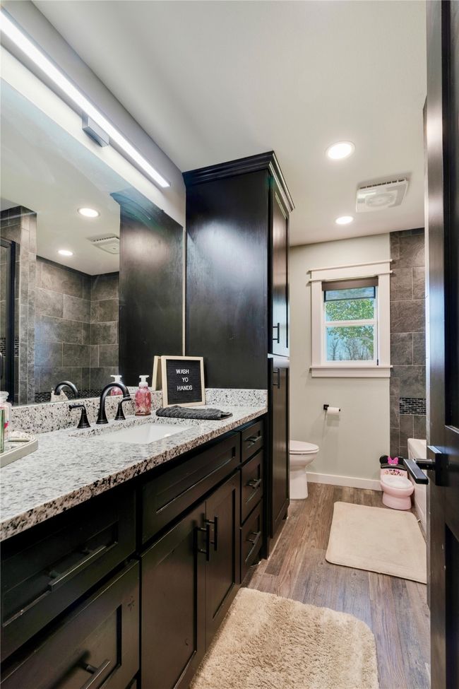 Full bath featuring visible vents, wood finished floors, toilet, and vanity | Image 15