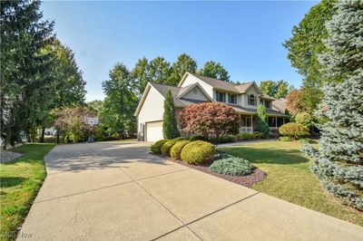 View of side of home with a garage and a yard | Image 2