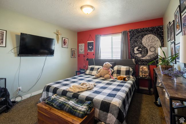 Bedroom featuring a textured ceiling and carpet | Image 15