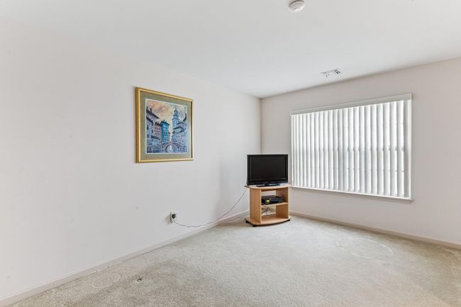 Unfurnished living room with carpet floors, baseboards, and visible vents | Image 22