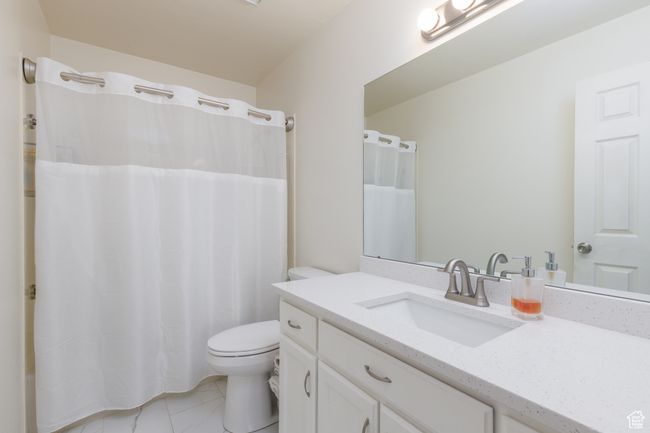 Bathroom with vanity, toilet, and tile patterned floors | Image 12