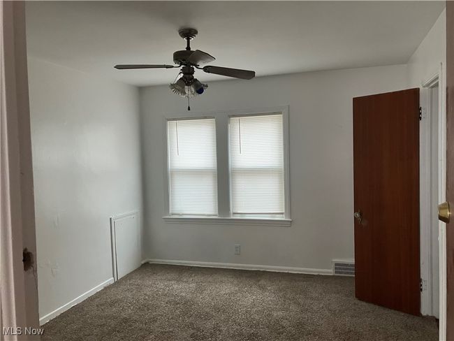 Empty room with baseboards, visible vents, ceiling fan, and carpet floors | Image 14
